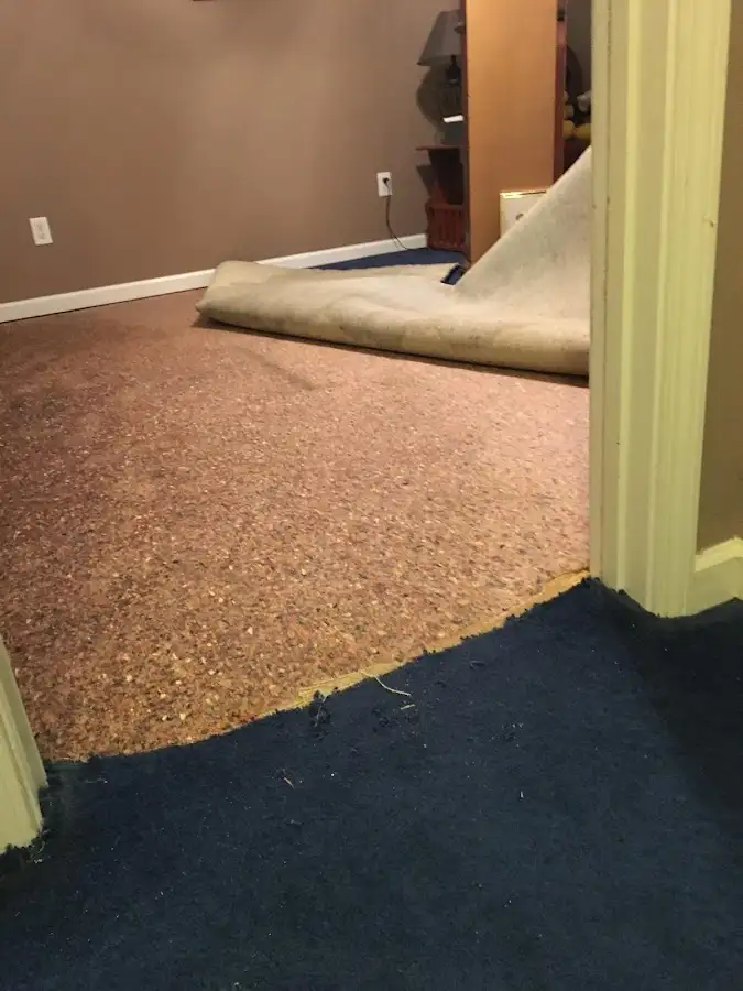 Carpet pad removal revealing water damage during Drying & Dehumidification in Highland Lakes
